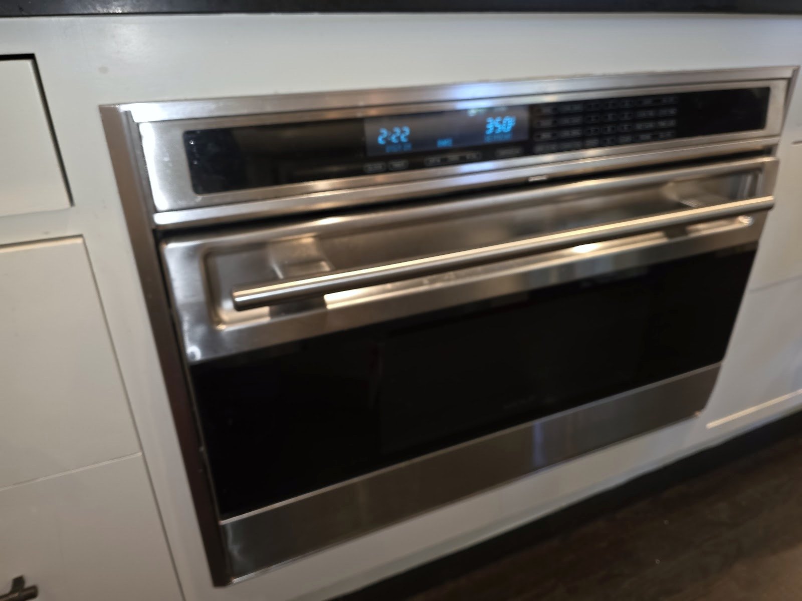 Stainless steel built-in wall oven with a digital control panel