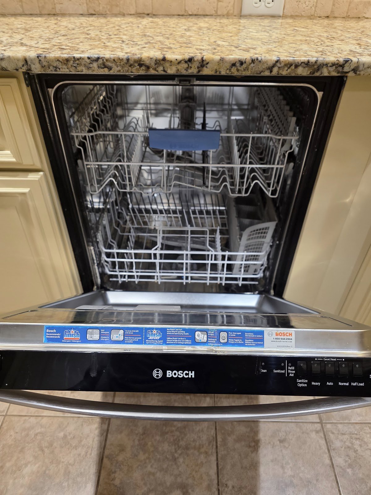 Open Bosch dishwasher showing its racks and wash compartment
