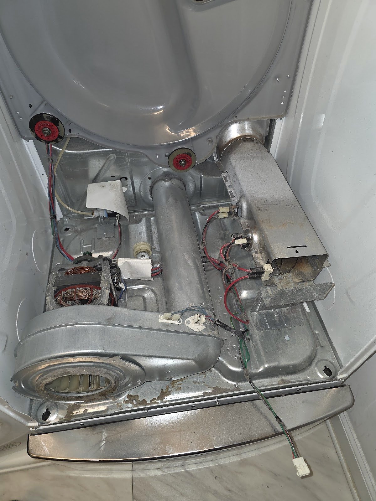 Dryer with its front and drum removed to expose the blower and heating assembly