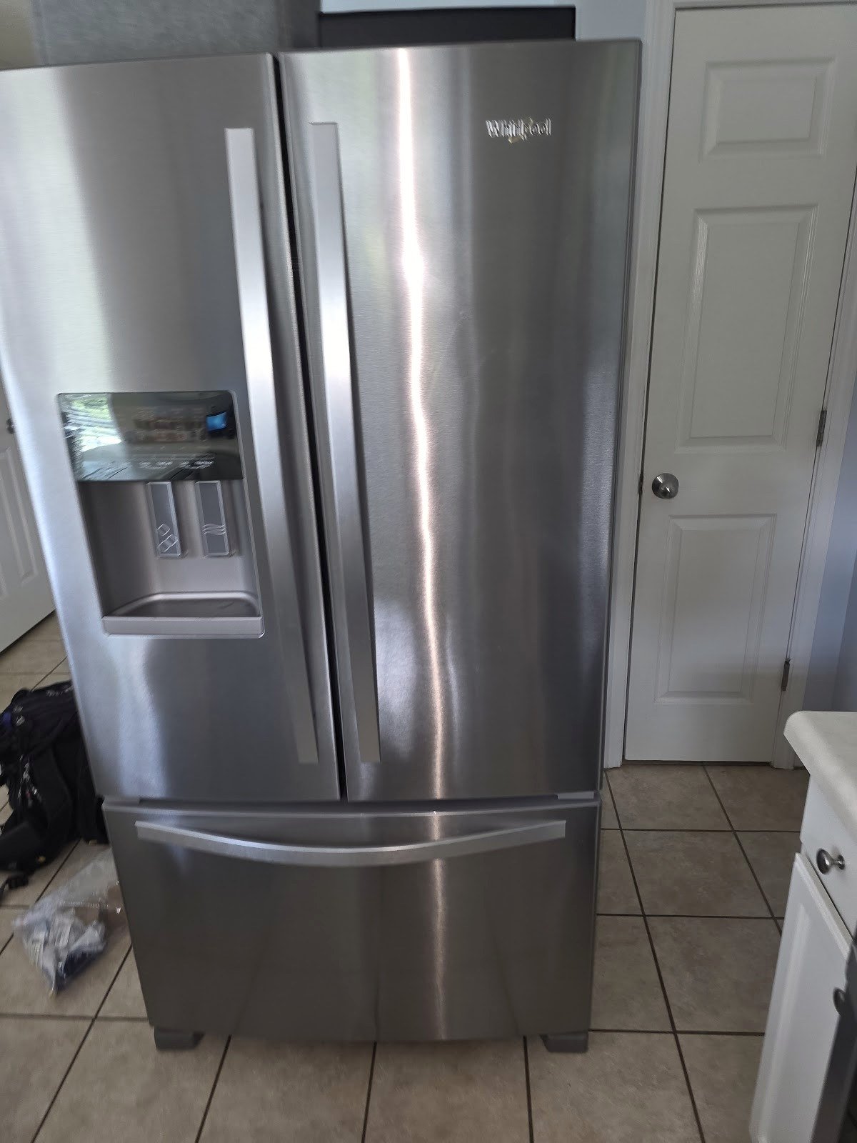 Stainless steel French-door refrigerator with a bottom freezer and water dispenser