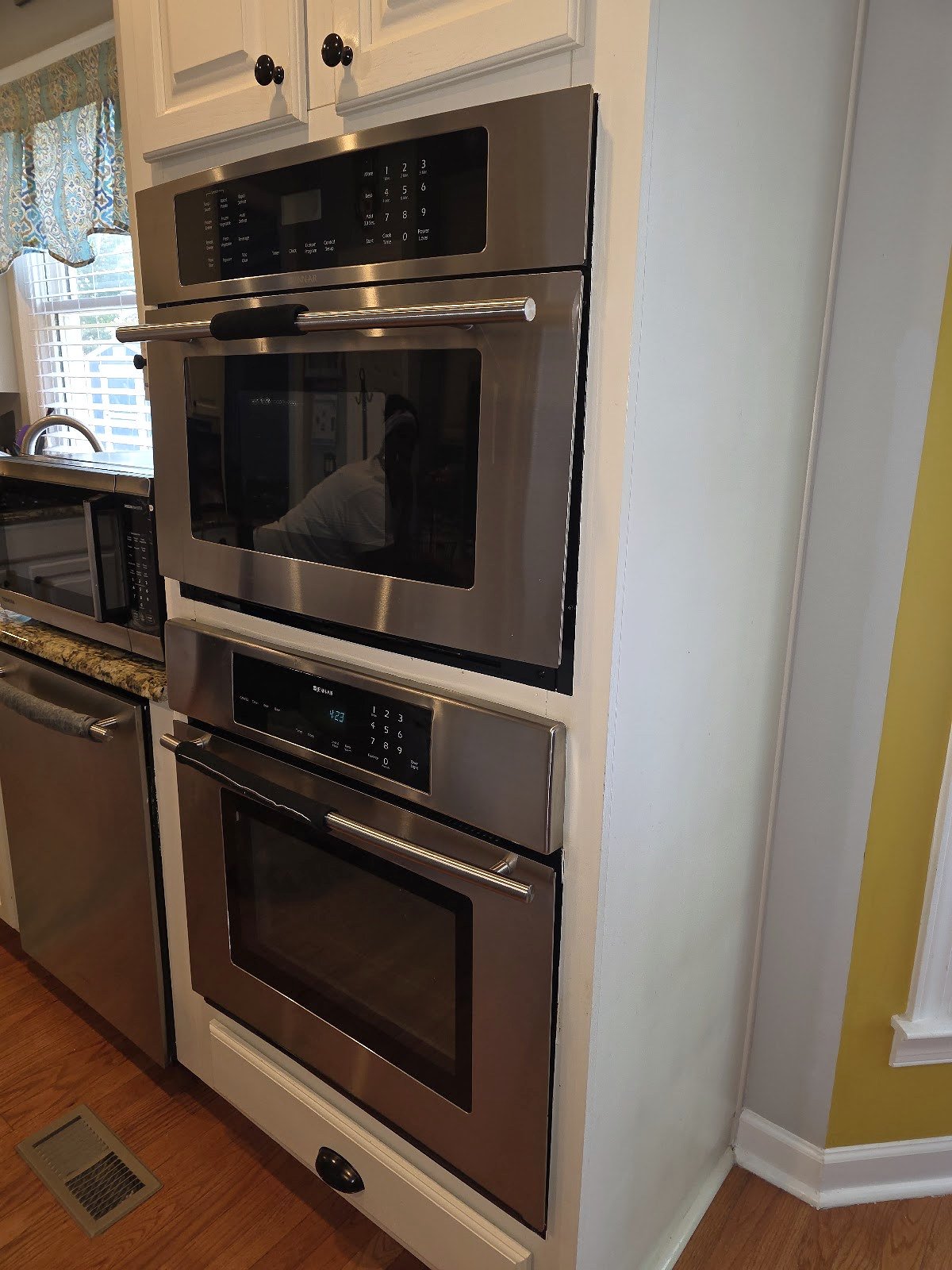 Stainless steel built-in double oven in a residential kitchen