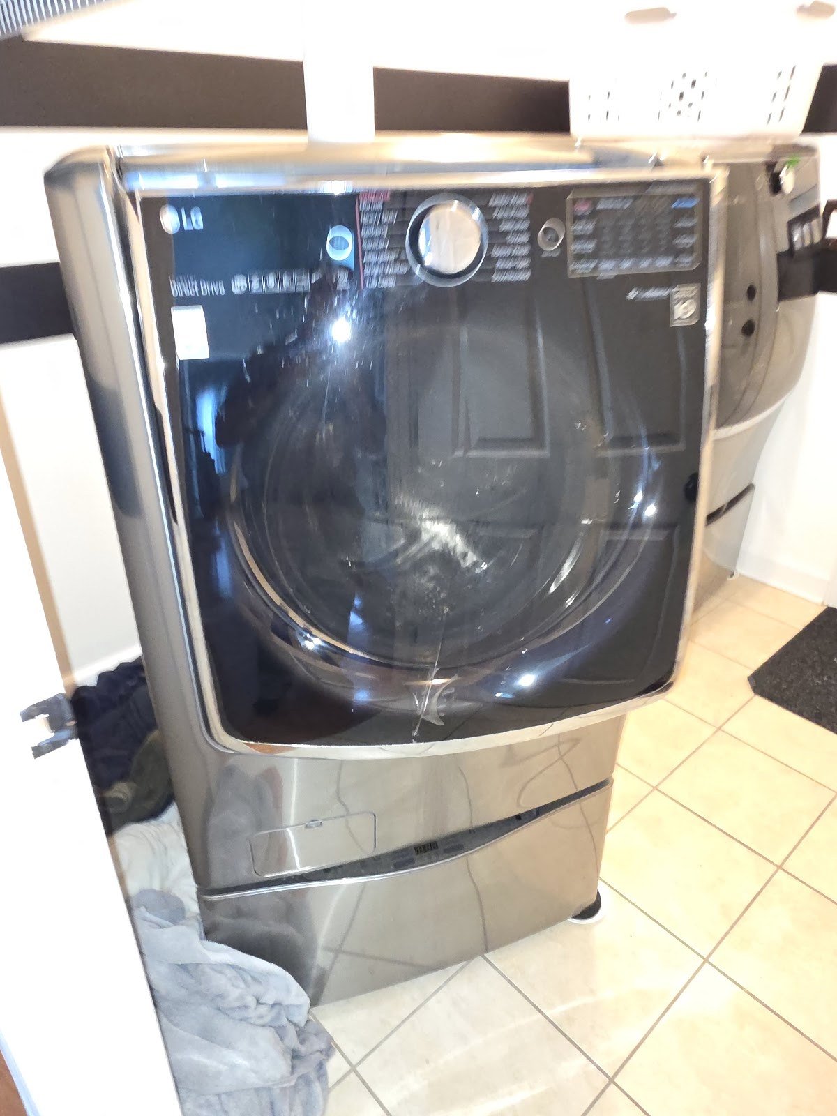 LG front-load washing machine with its upper service panel removed