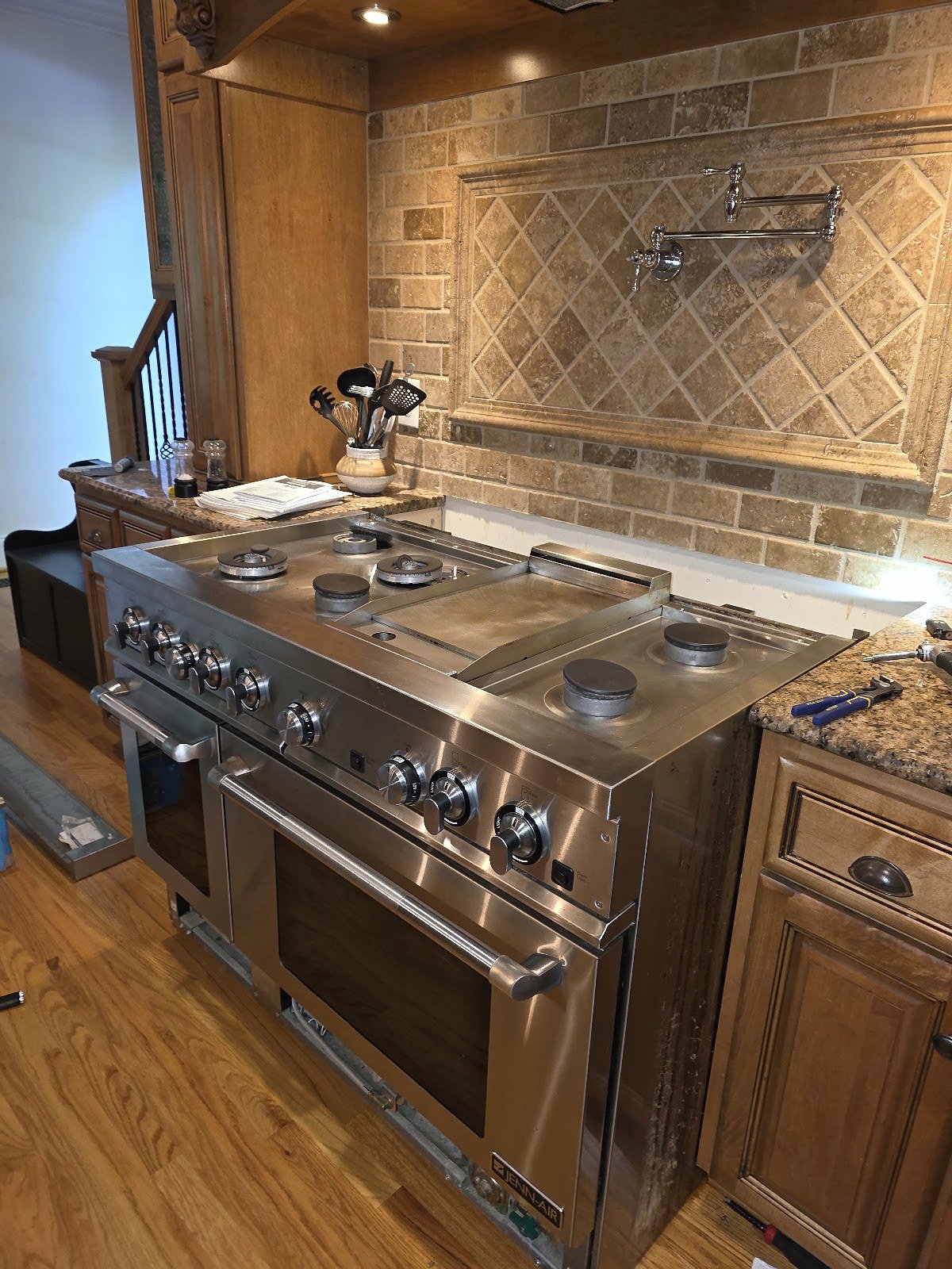 Wide stainless steel professional-style range with multiple burners and two oven doors