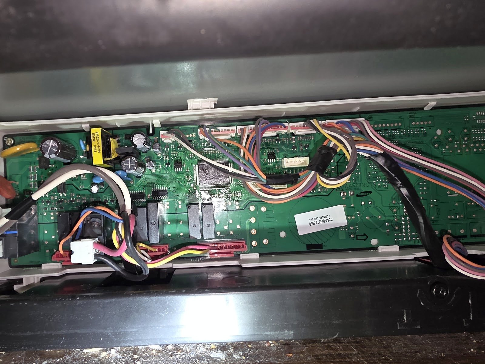Electronic circuit board and wiring exposed behind a range control panel