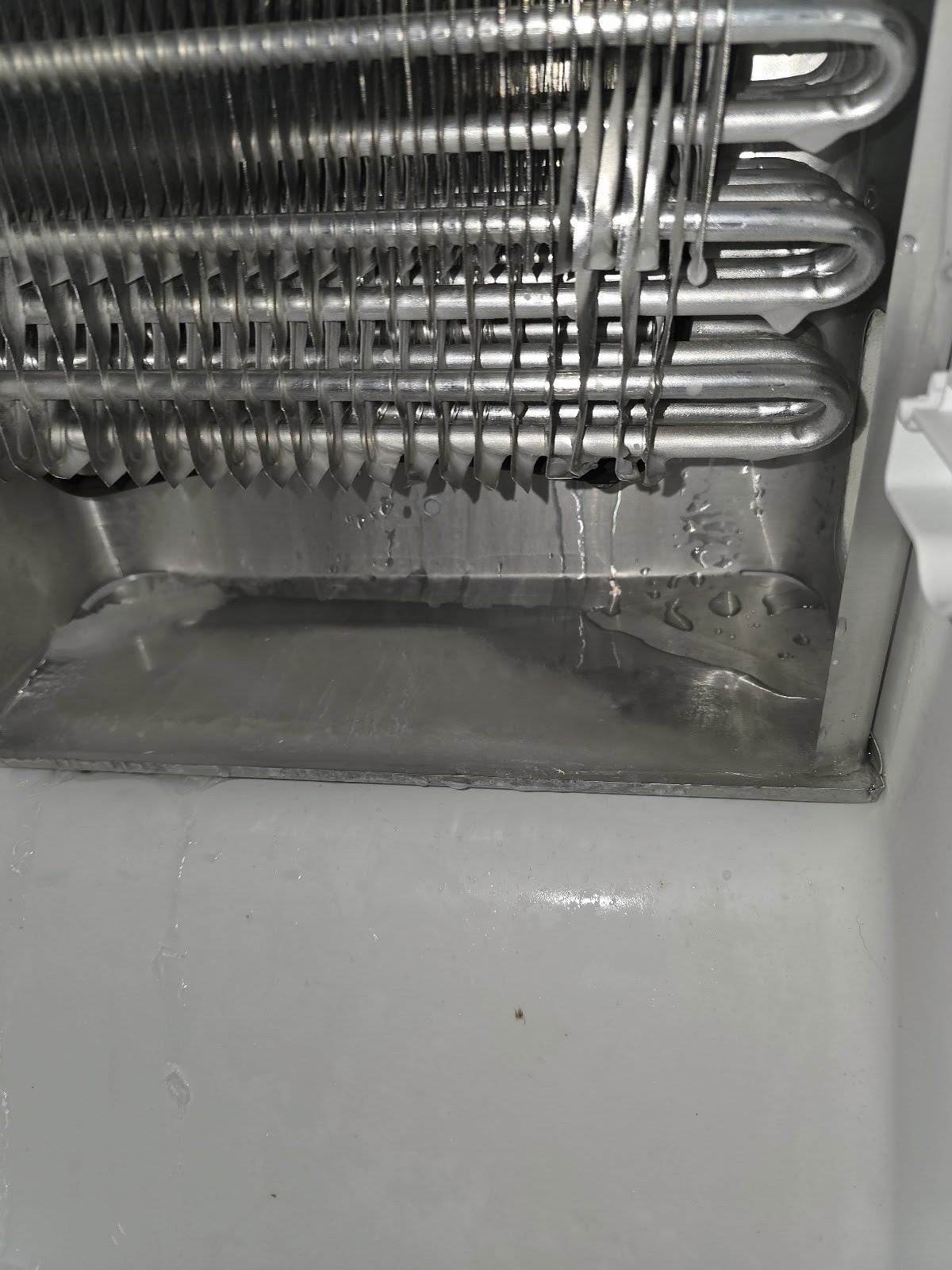 Close-up of an exposed refrigerator evaporator coil