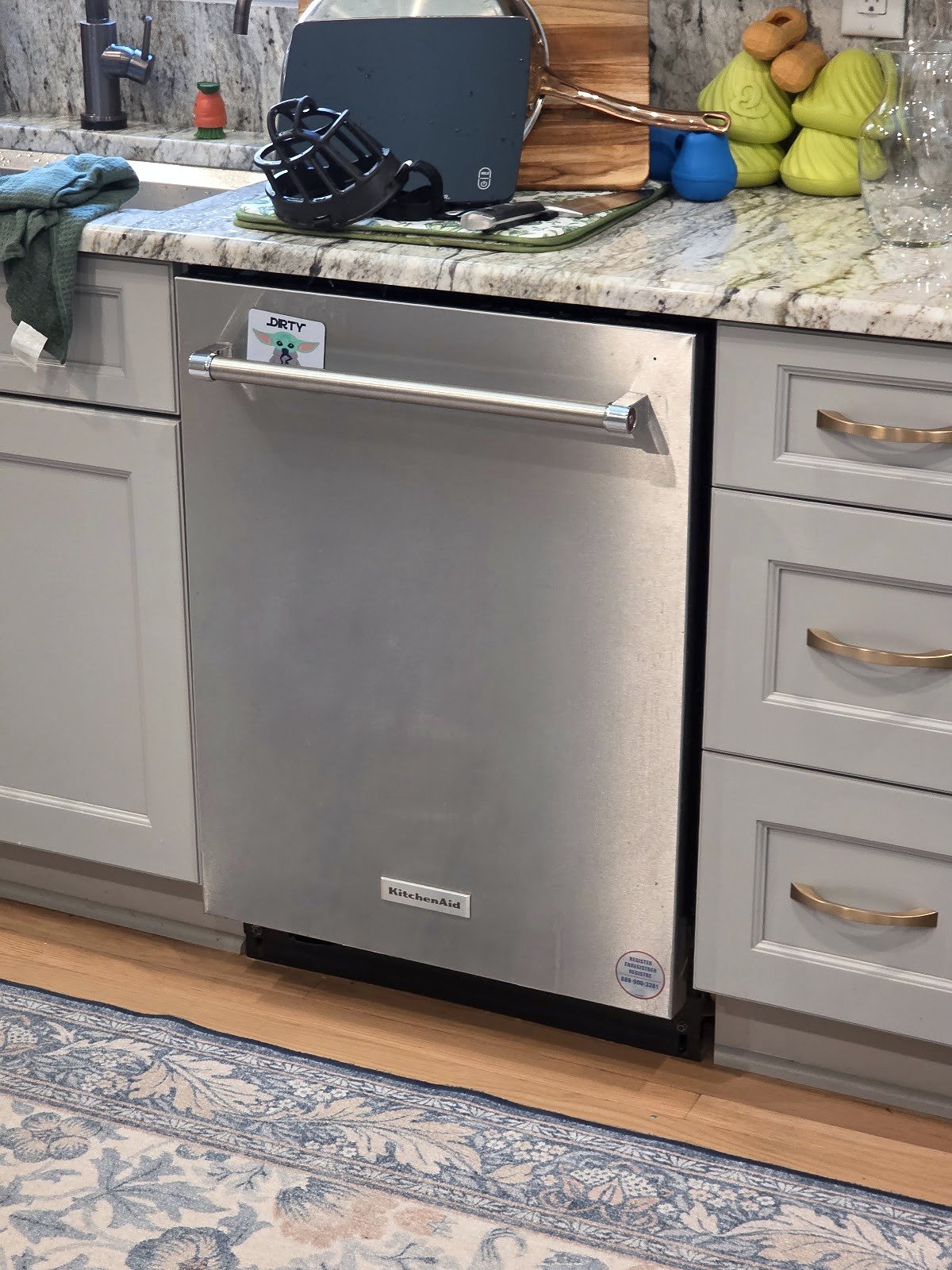 Stainless steel Bosch dishwasher fitted beneath a kitchen counter