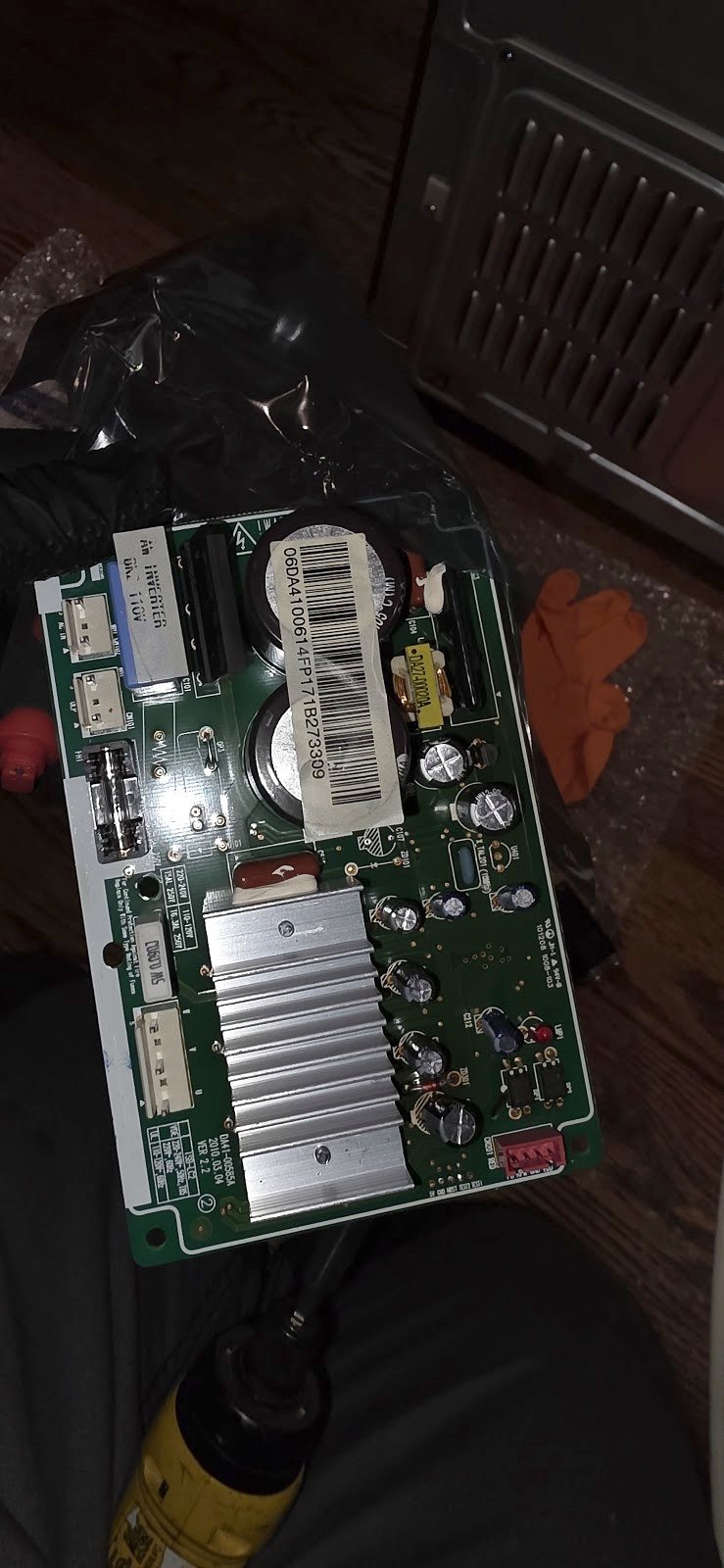 Electronic control board removed for inspection beside a wall oven