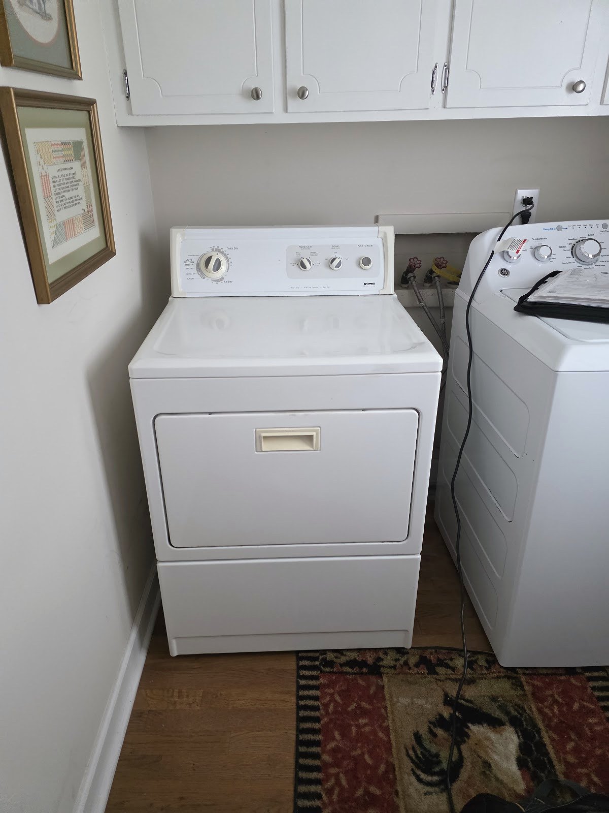 White clothes dryer beside a washing machine