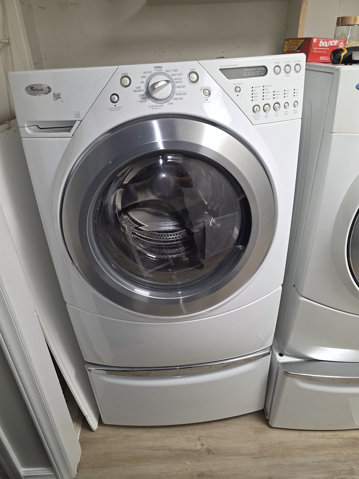 White front-load washing machine with a circular glass door