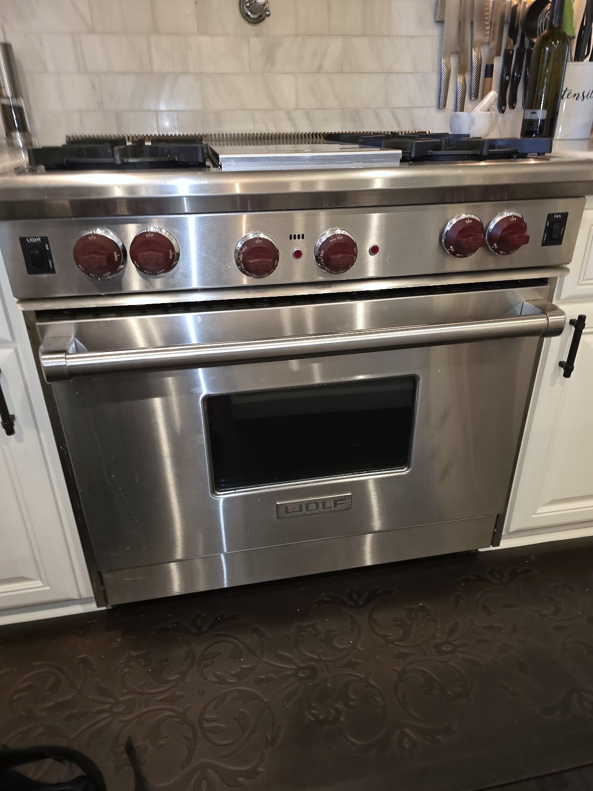 Stainless steel Wolf range with red control knobs